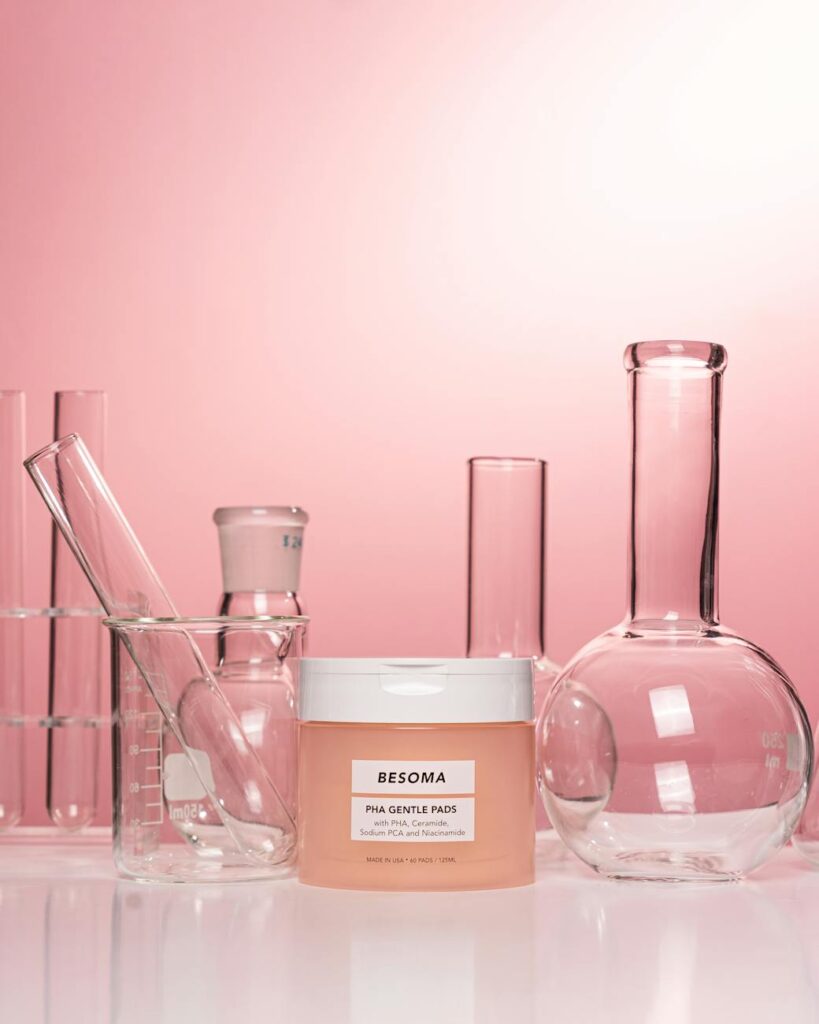 container of cream among lab glassware